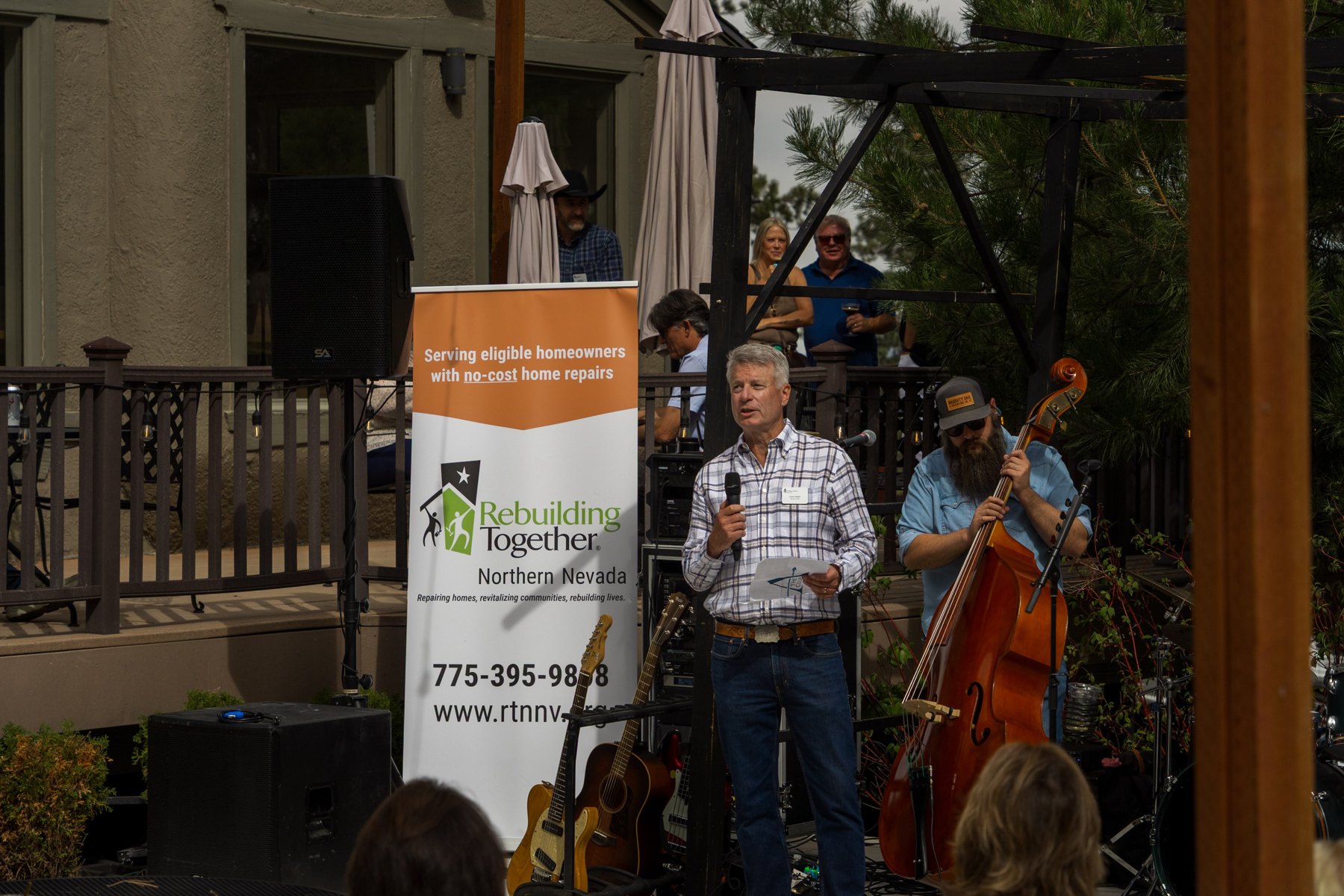 Board Chair Chuck Ziegler thanking guests from the stage at Boots and Builds