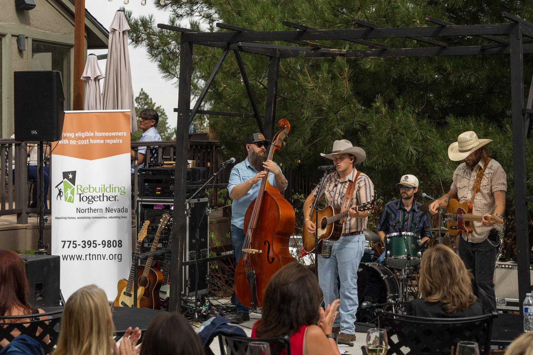 Jakota Wass and his band performing on the patio at The Lodge during Boots and Builds