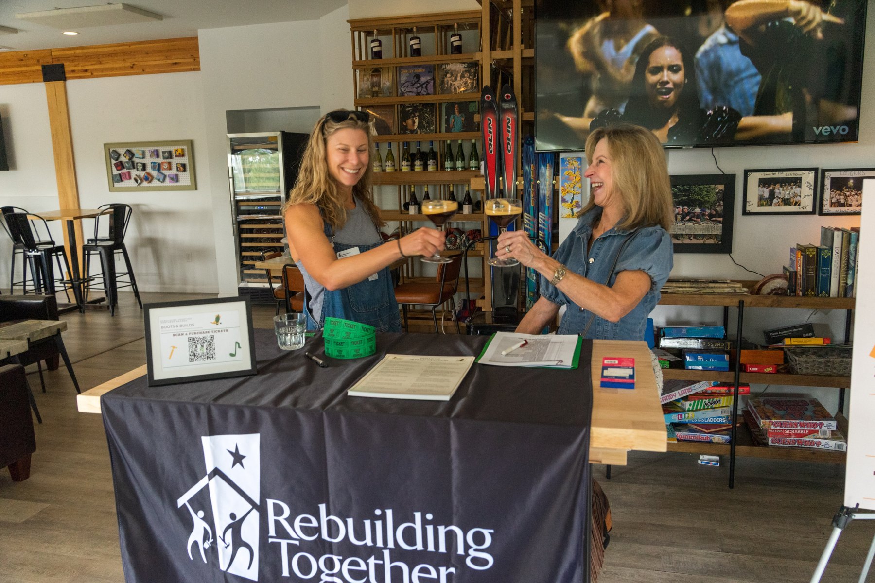 Volunteers welcoming guests at the Boots and Builds check-in table